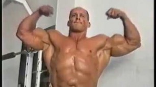 'mature muscle man flexes'